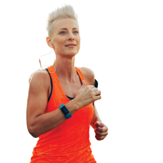 Person jogging outdoors in a bright orange athletic top, wearing earbuds and a fitness tracker.