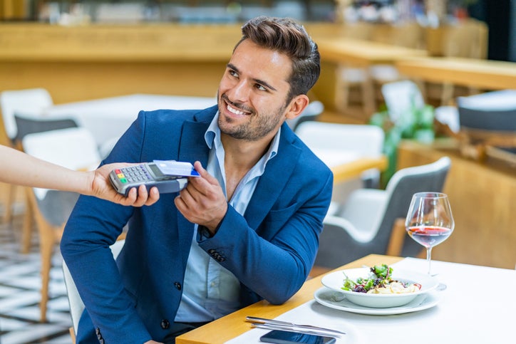 smiling businessman dining in restaurant